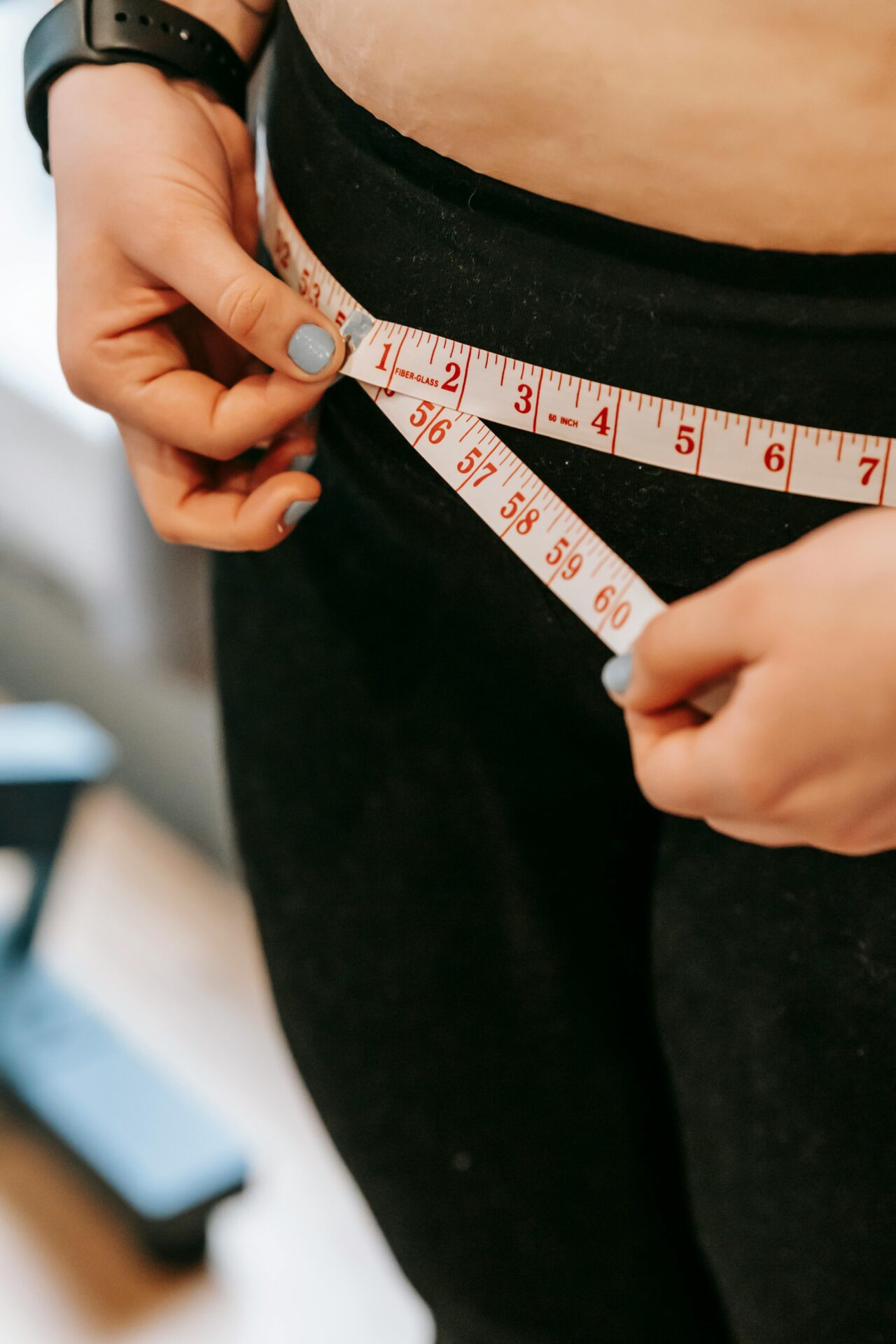 Woman measuring her hips Woman measuring her hips<br />